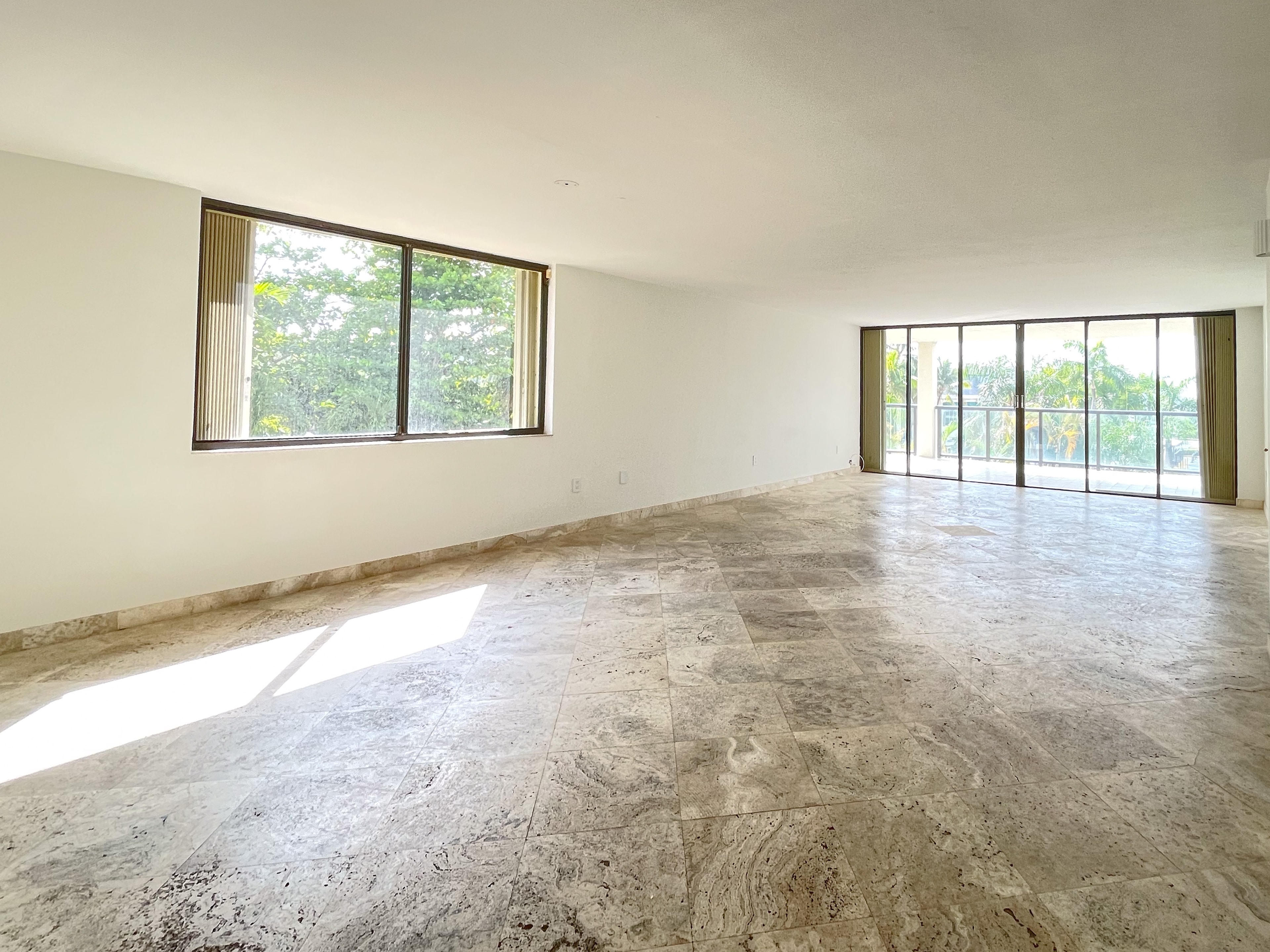 Corner living space with garden window and terrace access
