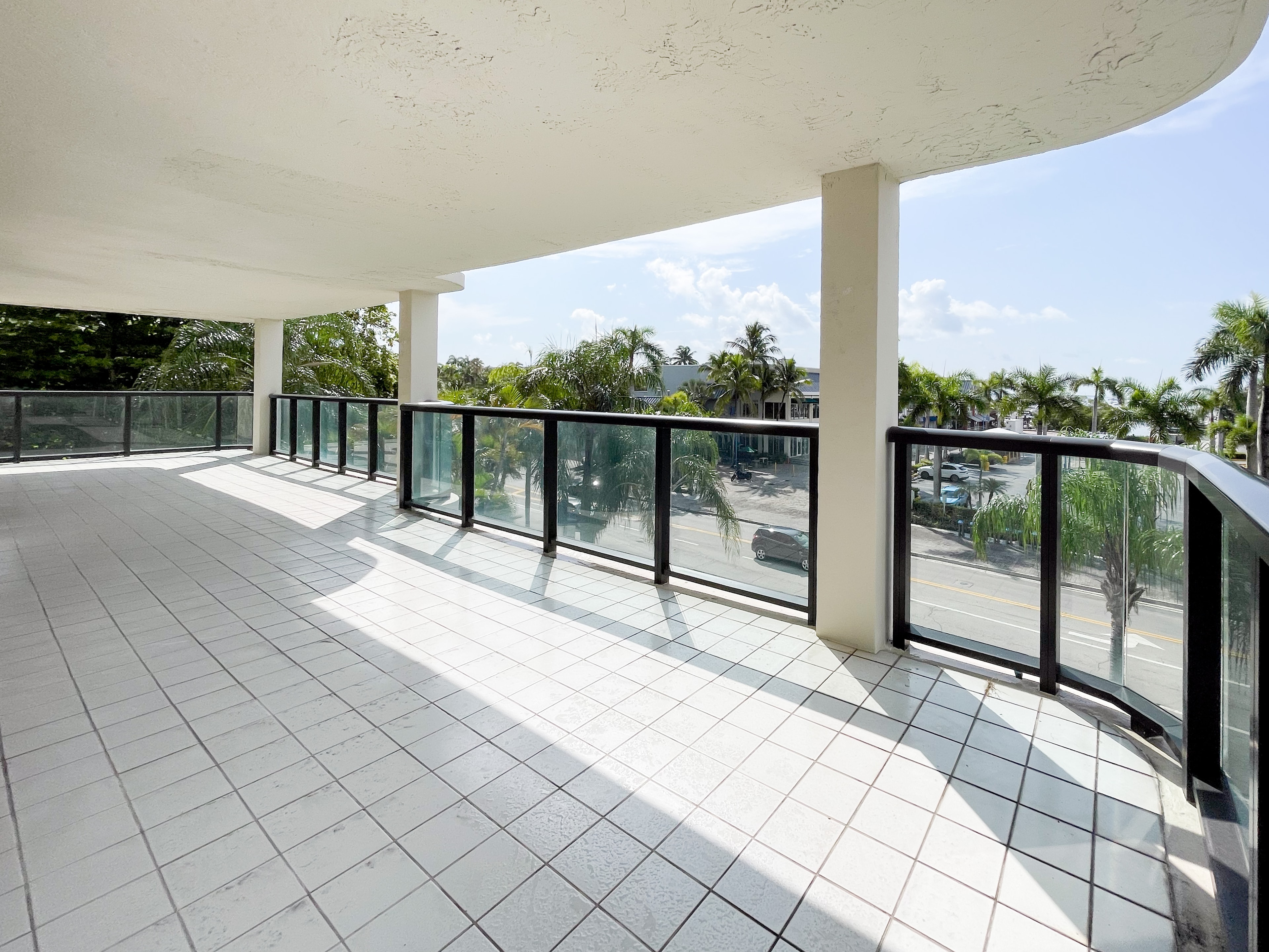 Wide panoramic terrace with wraparound glass railings